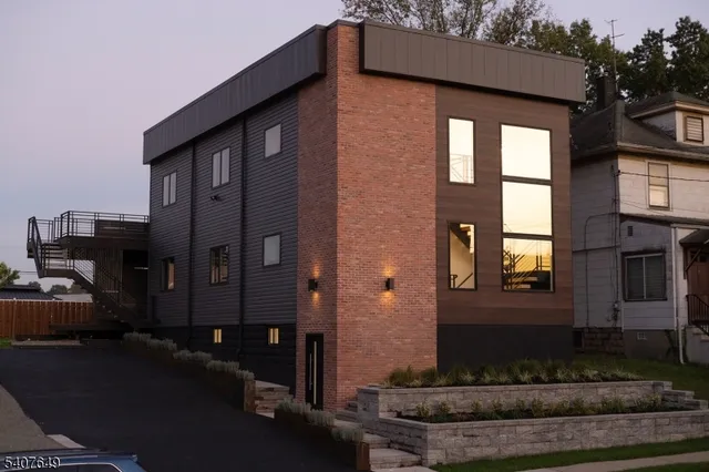 a front view of a house with plants