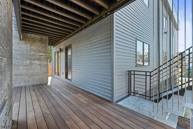 a view of outdoor space with wooden floor and stairs