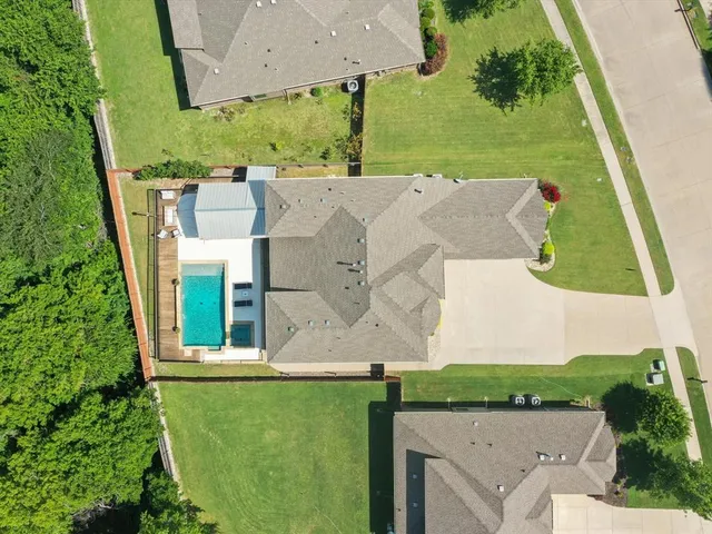 an aerial view of residential house with outdoor space and swimming pool