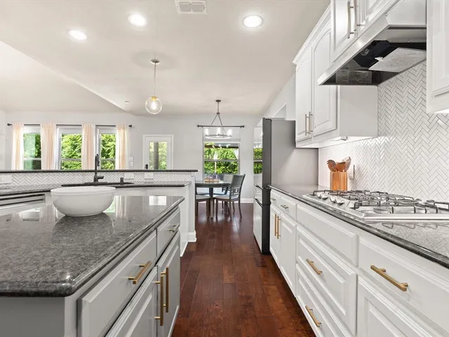 a kitchen with a stove a sink and a wooden cabinets