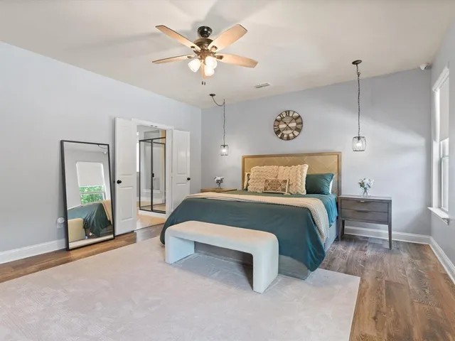 a bedroom with a bed and a chandelier