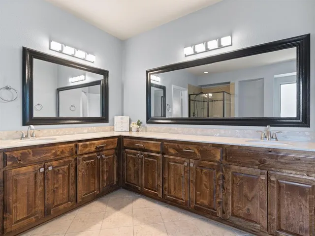 a spacious bathroom with a double vanity sink double and a mirror