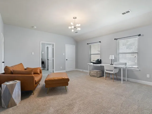 a bedroom with furniture and a chandelier