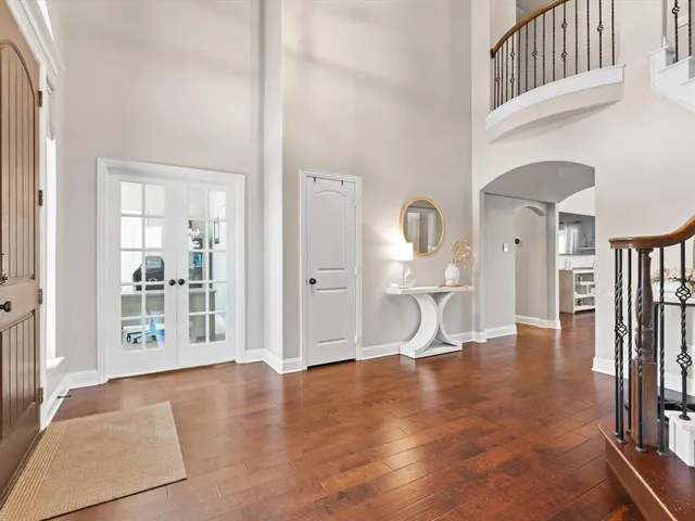 a view of a livingroom with wooden floor and furniture