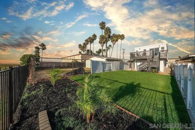 a view of a garden with a building in the background