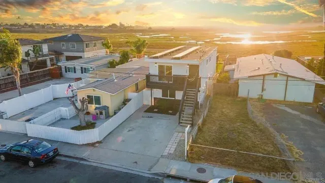 a view of a white building with a view of a house with a ocean view