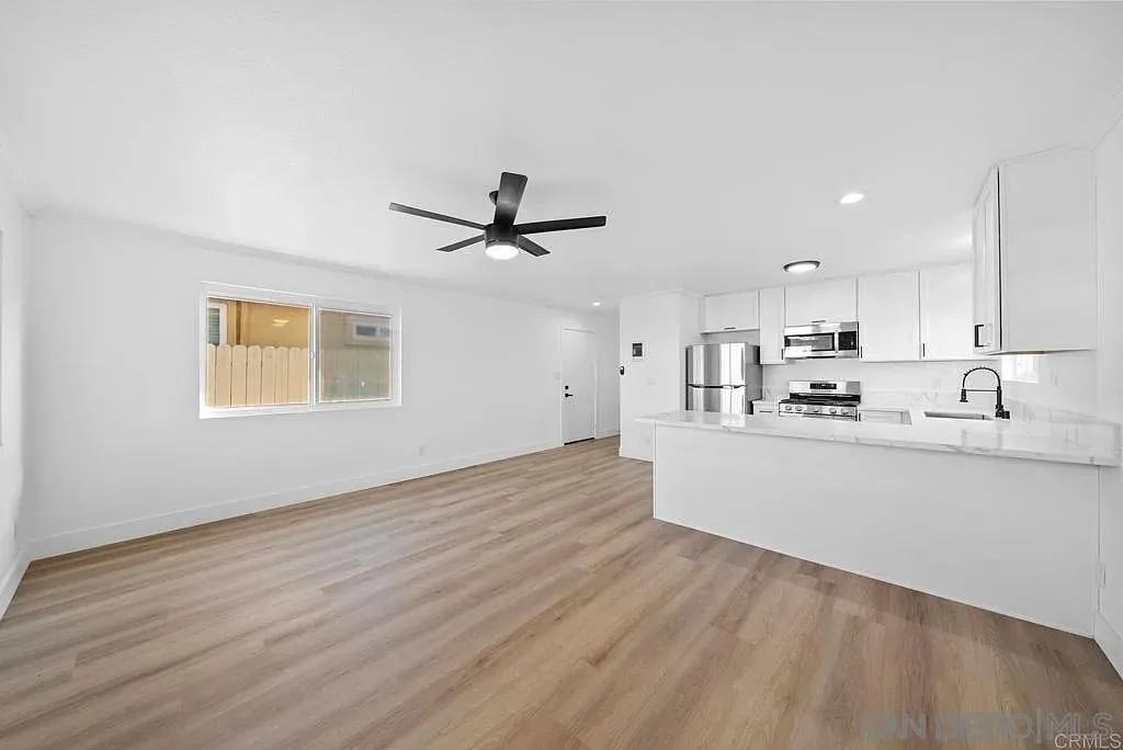 378 7th Street Imperial Beach, CA 91932 - Photo 8 of 41 a view of a kitchen with wooden floor a sink and a window