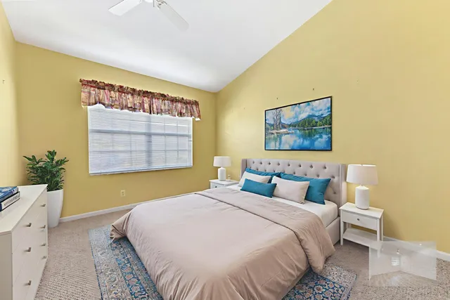 a bedroom with a bed and a painting on the wall