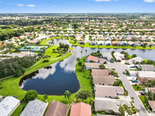 an aerial view of residential houses with outdoor space and swimming pool