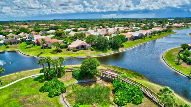an aerial view of a house with a garden and lake view