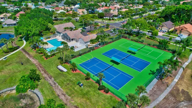 an aerial view of a tennis ground and a yard