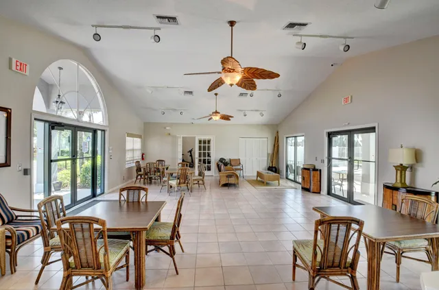 a view of a dining room and livingroom with furniture wooden floor a chandelier