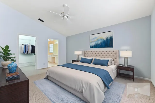 a bedroom with a bed and a potted plant