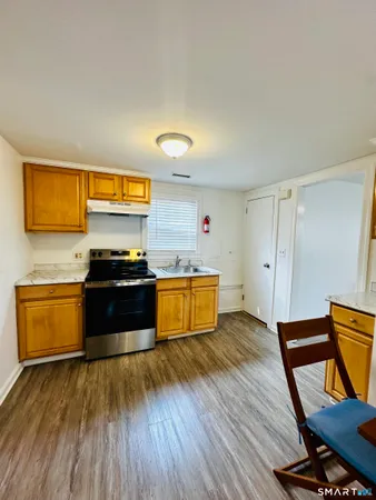 a kitchen with wooden floors and a stove