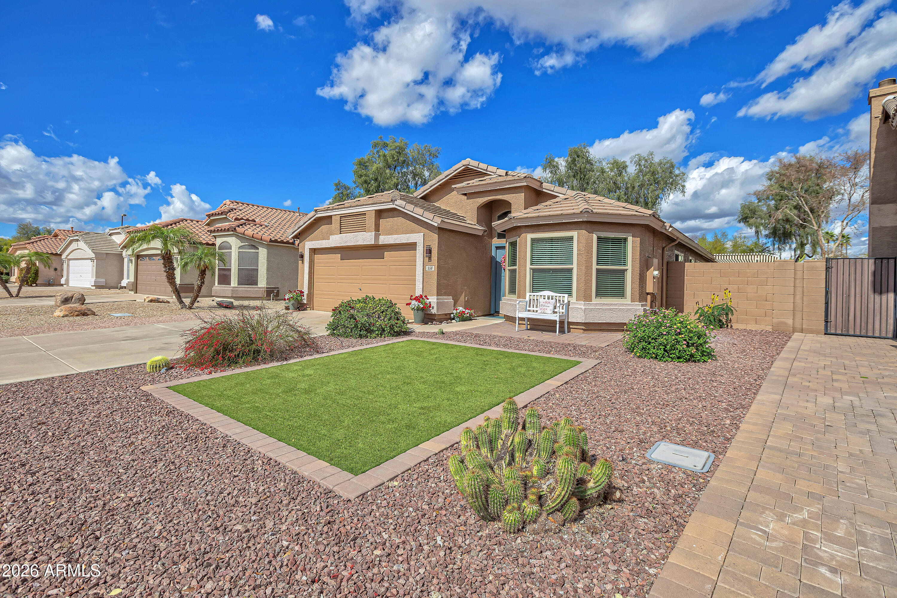 558 East Devon Drive Gilbert, AZ 85296 - Photo 1 of 42 a front view of a house with a garden