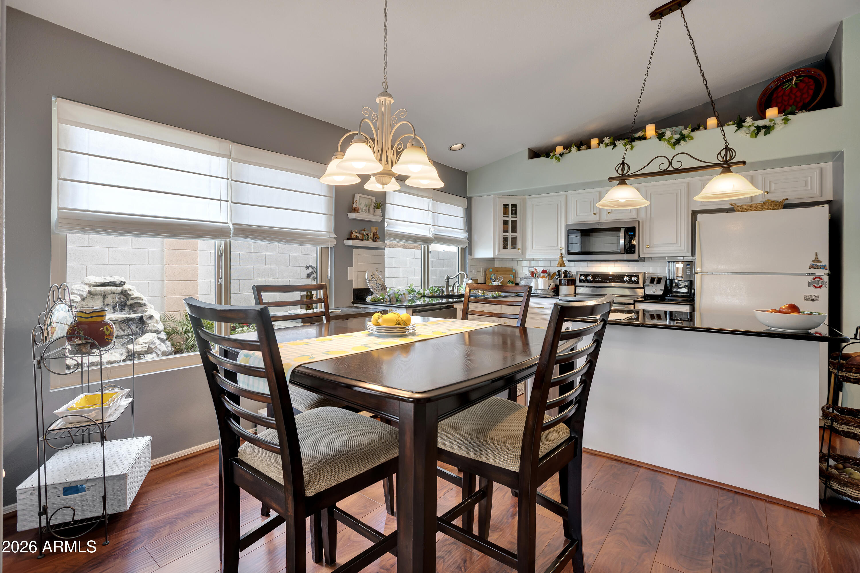 558 East Devon Drive Gilbert, AZ 85296 - Photo 11 of 42 a view of a dining room with furniture window and wooden floor