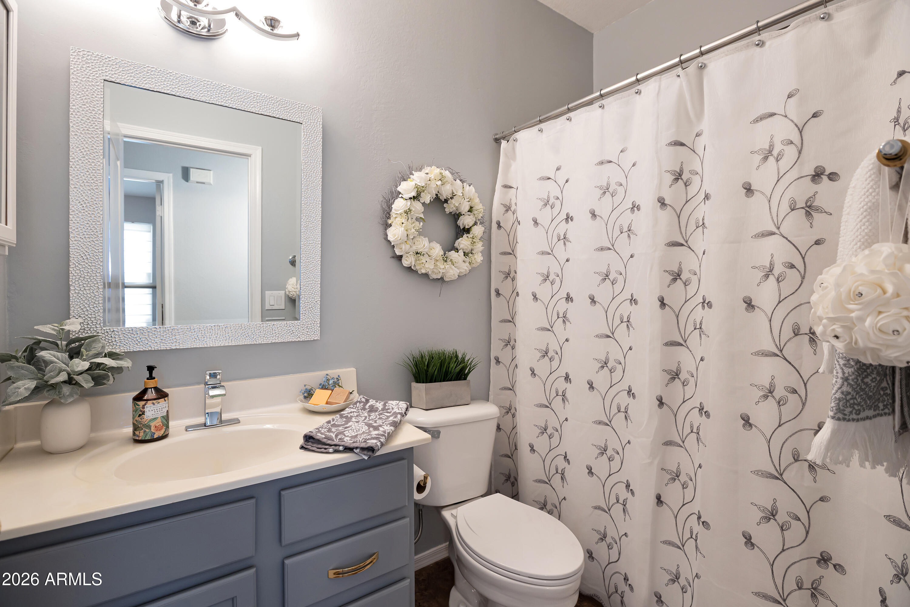 558 East Devon Drive Gilbert, AZ 85296 - Photo 19 of 42 a bathroom with a granite countertop sink mirror and toilet