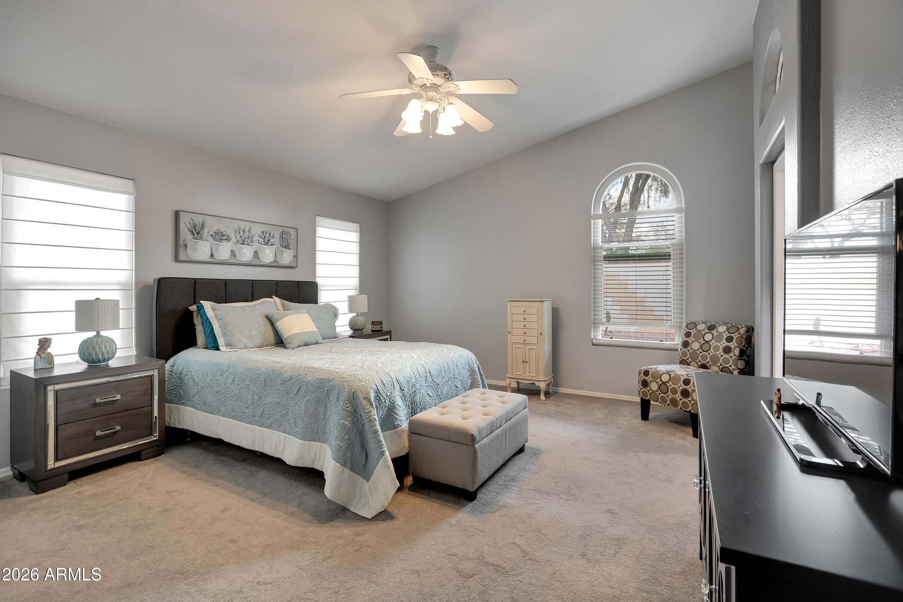 558 East Devon Drive Gilbert, AZ 85296 - Photo 24 of 42 a spacious bedroom with a bed a couch and a large window