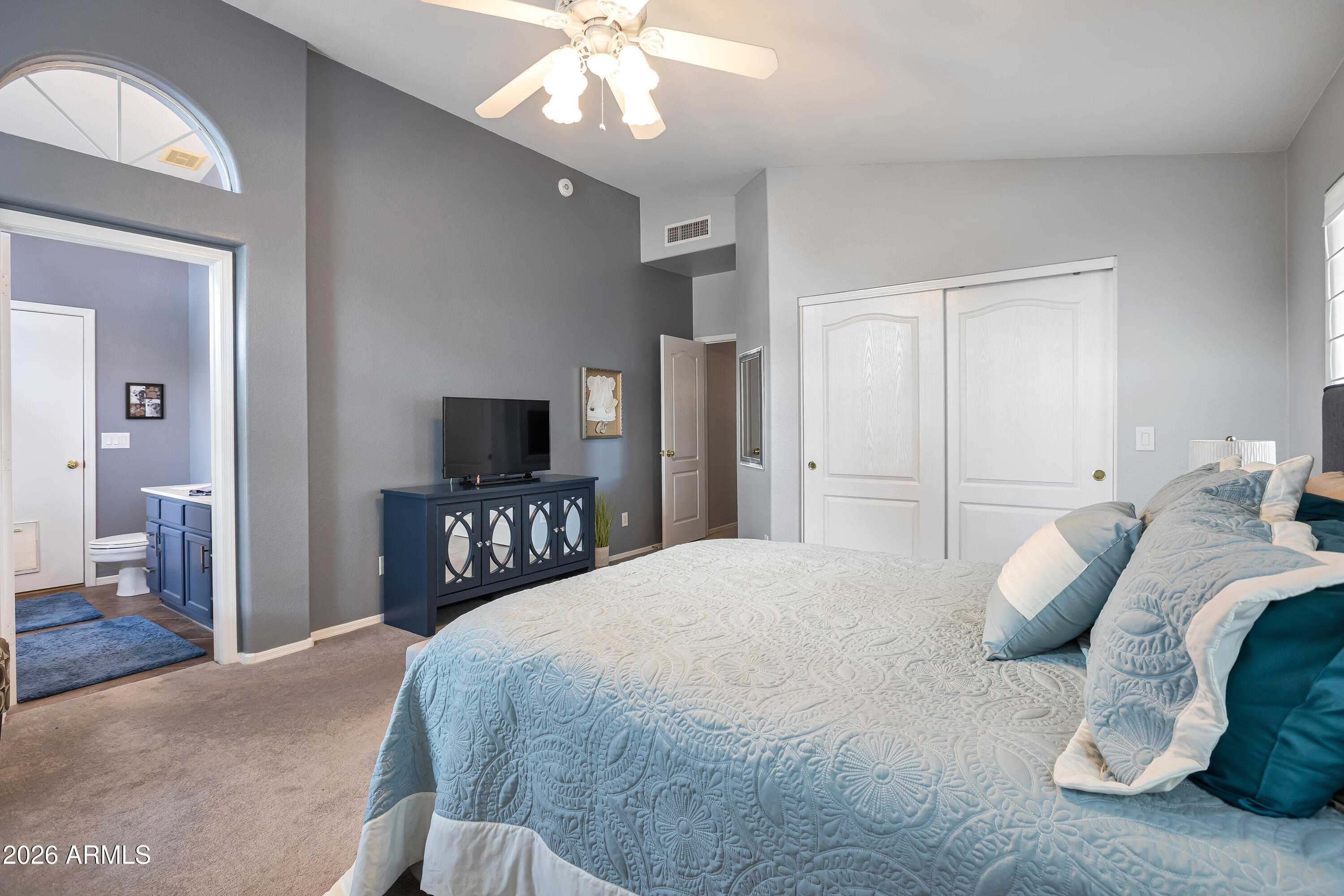 558 East Devon Drive Gilbert, AZ 85296 - Photo 25 of 42 a bedroom with a bed and a chandelier