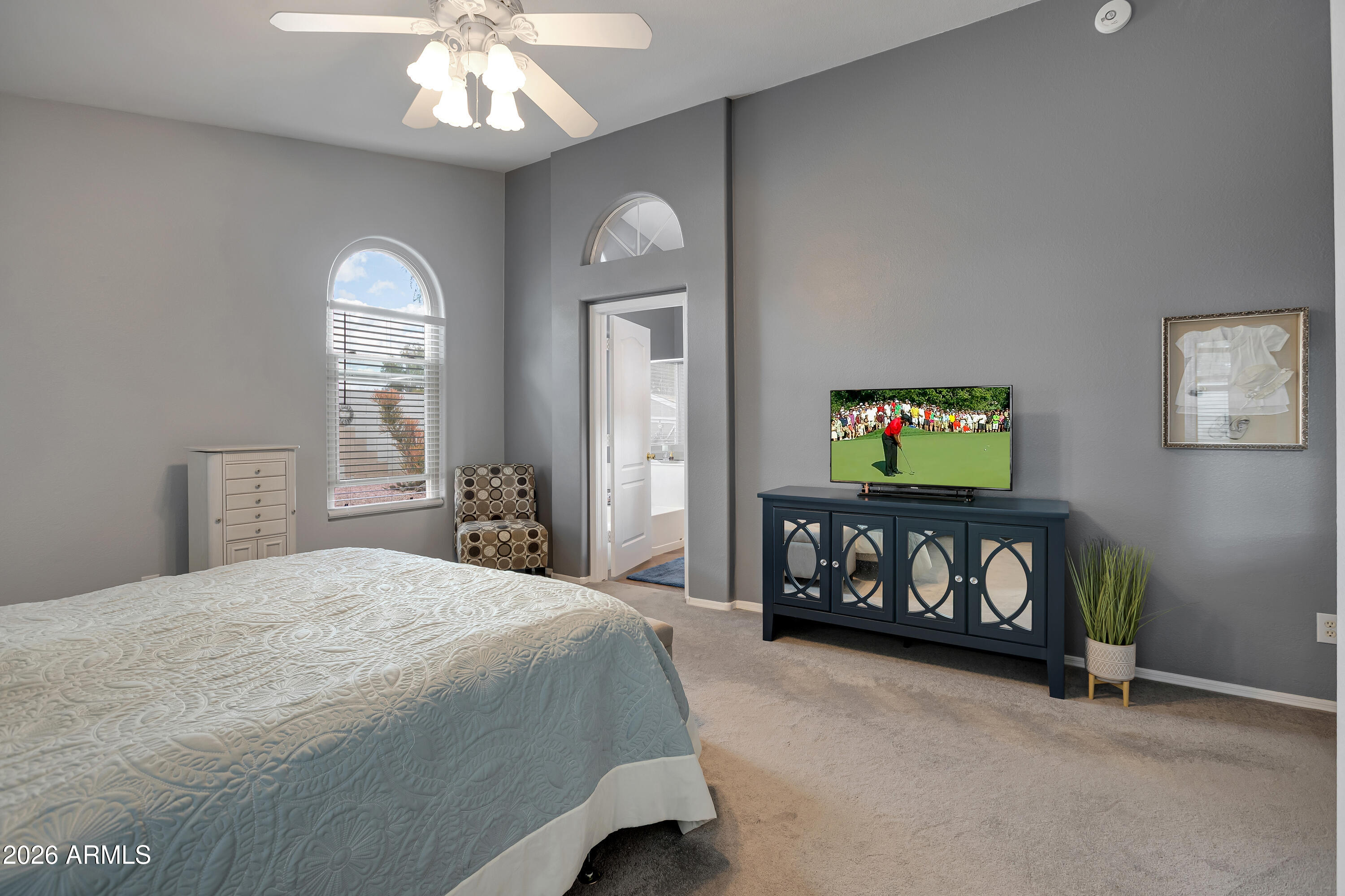 558 East Devon Drive Gilbert, AZ 85296 - Photo 26 of 42 a bedroom with a bed and a tv on dresser