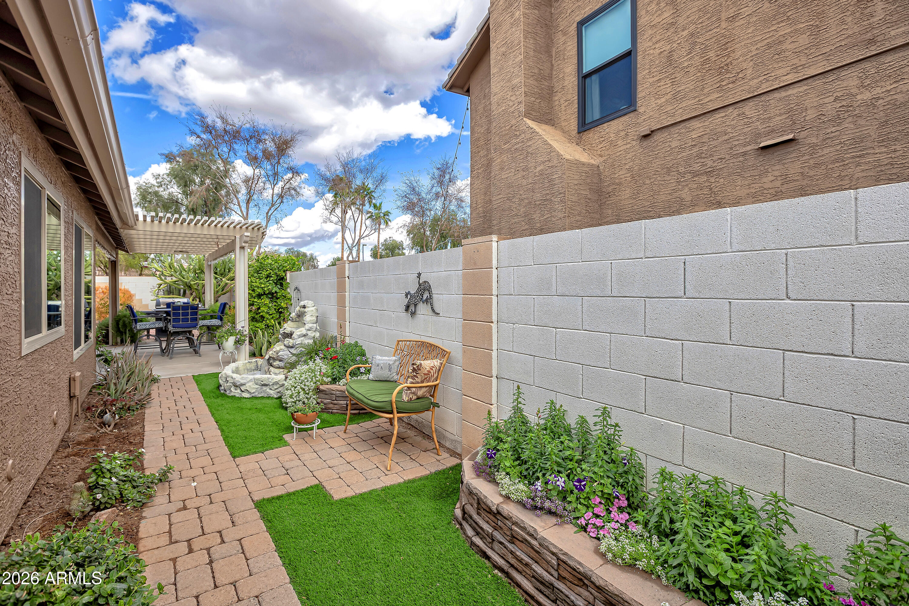 558 East Devon Drive Gilbert, AZ 85296 - Photo 31 of 42 a view of a chair and tables in the backyard of the house
