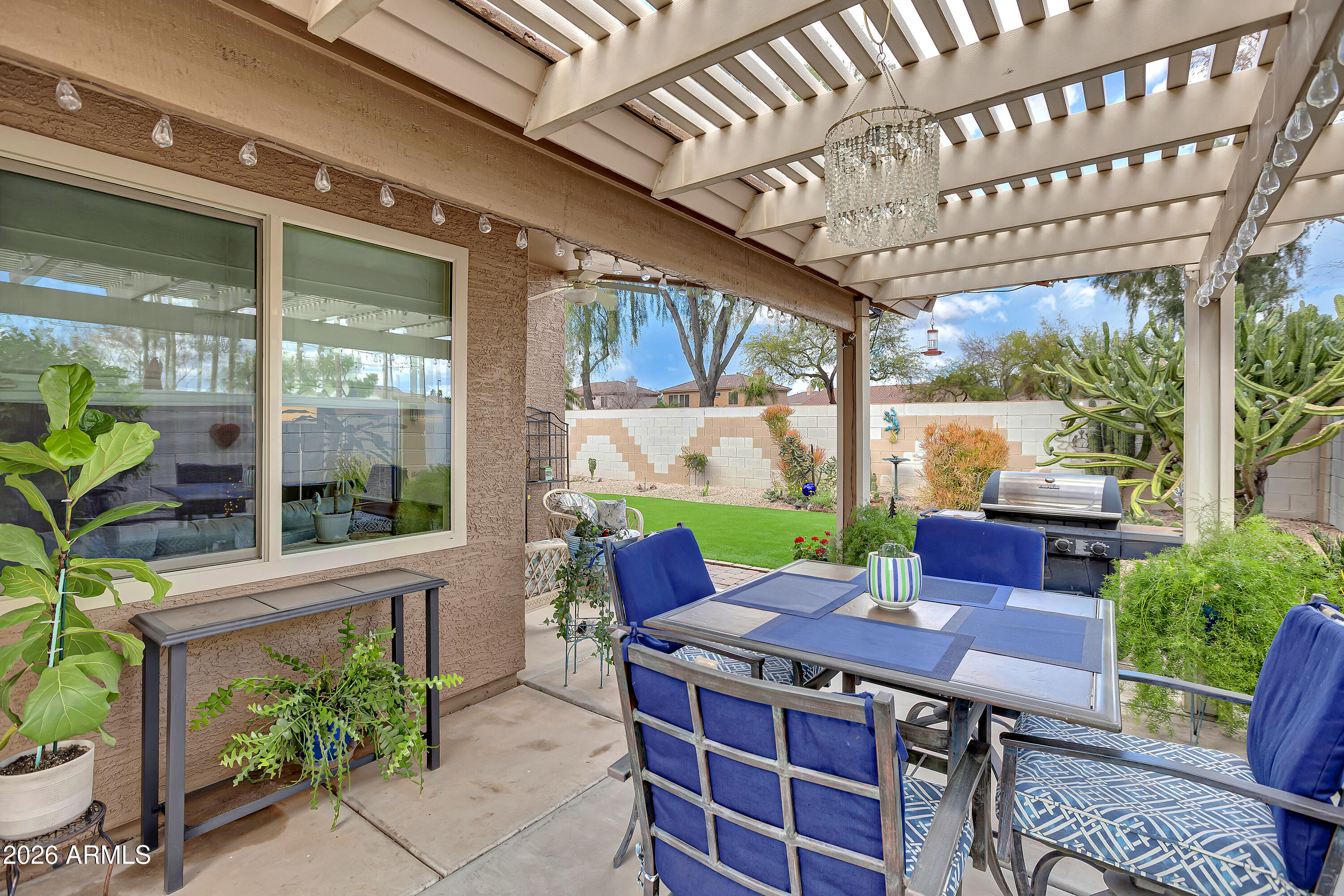 558 East Devon Drive Gilbert, AZ 85296 - Photo 32 of 42 a view of an outdoor sitting area with a table and chairs