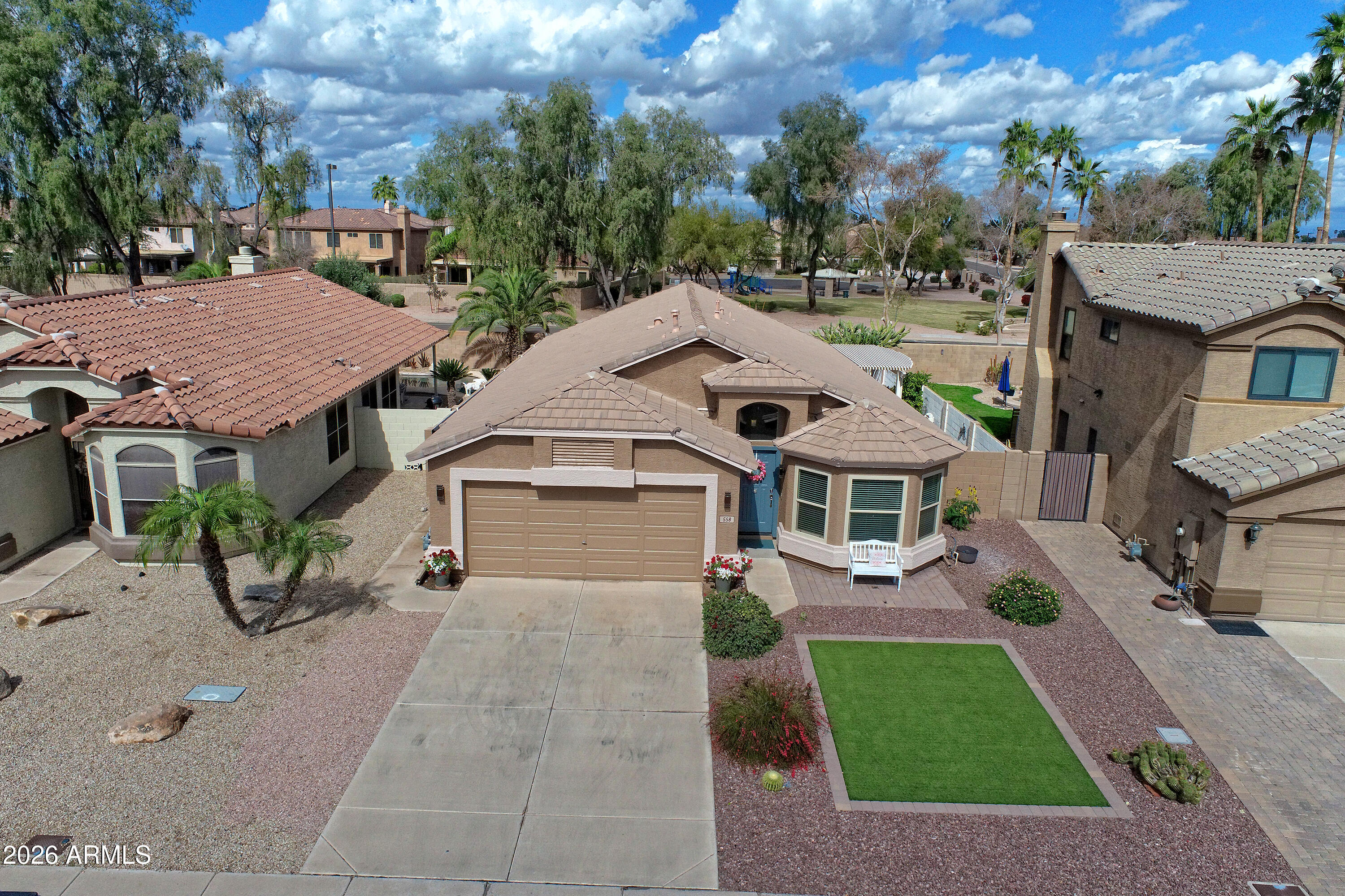 558 East Devon Drive Gilbert, AZ 85296 - Photo 39 of 42 a view of a house with a yard plants and large tree