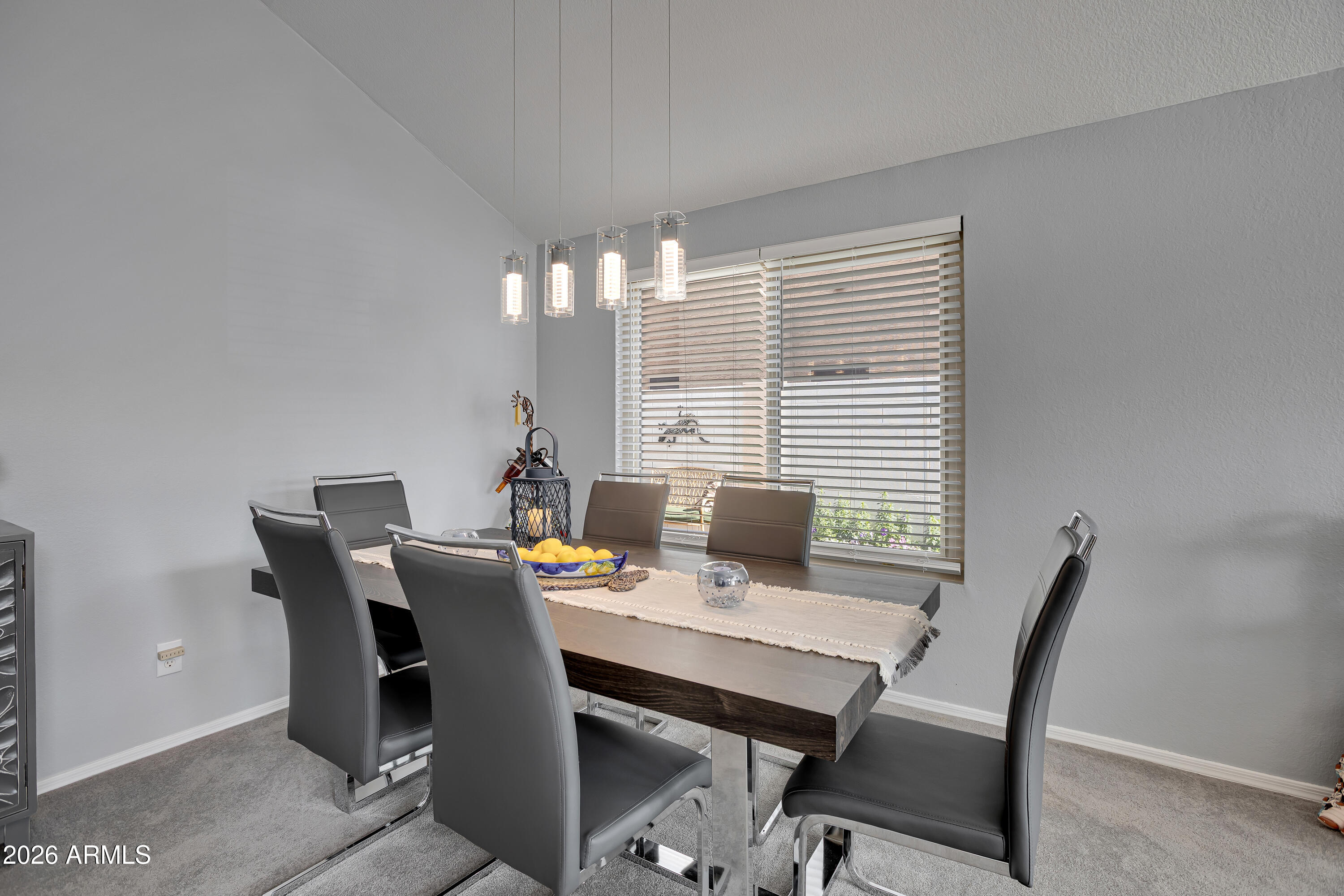 558 East Devon Drive Gilbert, AZ 85296 - Photo 4 of 42 a view of a dining room with a table and chairs