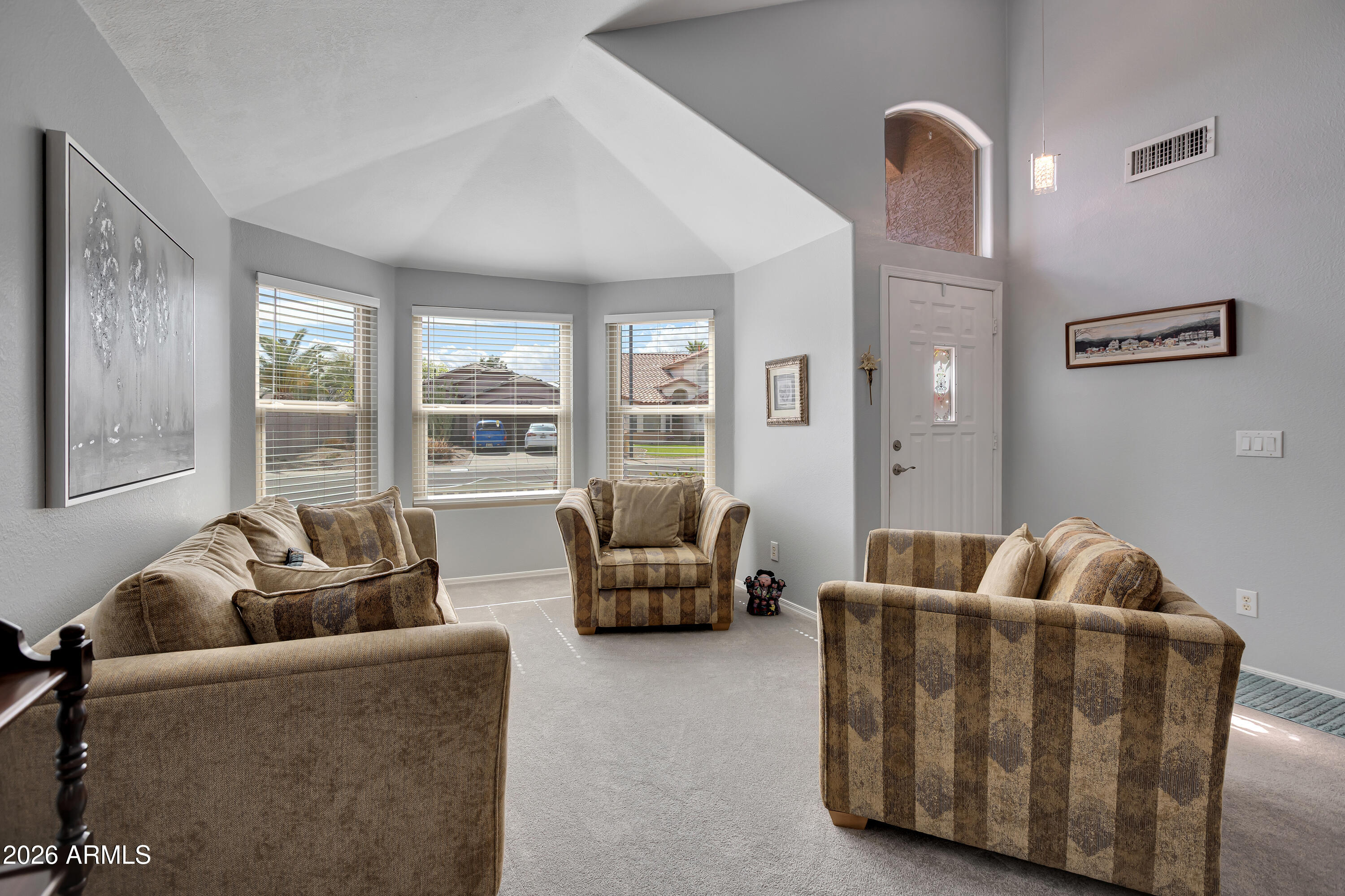 558 East Devon Drive Gilbert, AZ 85296 - Photo 7 of 42 a living room with furniture and a large window