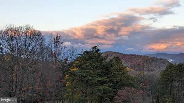a living room with furniture a flat screen tv and a floor to ceiling window