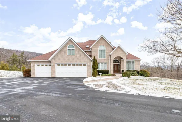 a view of a dining room with furniture one side kitchen view and wooden floor