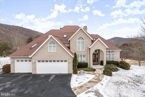a living room with fireplace furniture and a large window