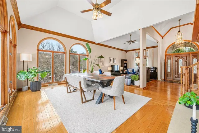 a hallway with wooden floor closet and a living room