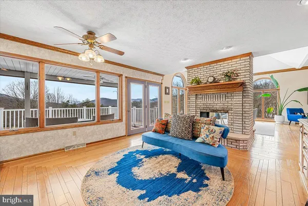 a bedroom with a bed couch and a large window