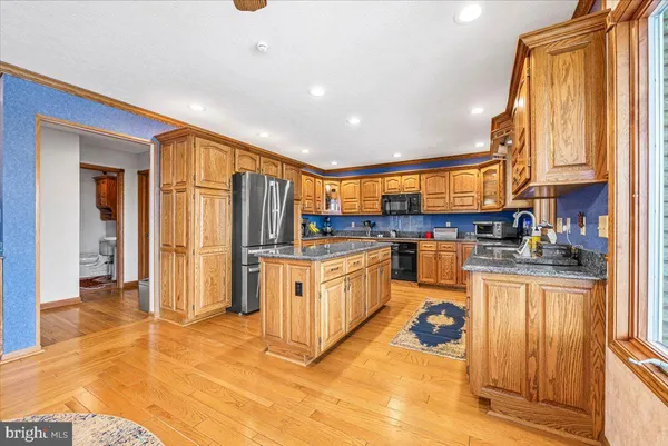 a view of a livingroom with wooden floor and a hallway