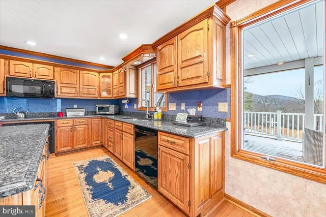 a living room with a black white checkered floor with couches chair and a coffee table