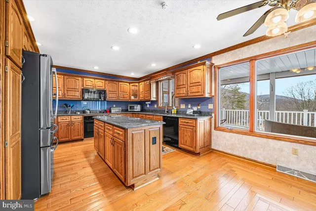 a view of hallway with wooden floor