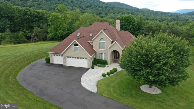an aerial view of a house with a yard