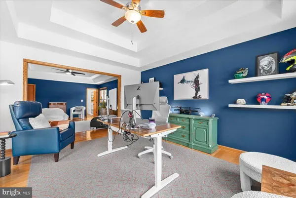 a living room with couch and a floor to ceiling window or wooden floor