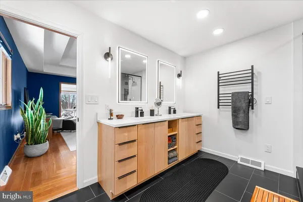 a view of a houses with snow on the road