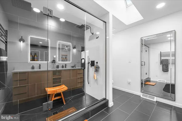 a front view of a house with a yard covered in snow