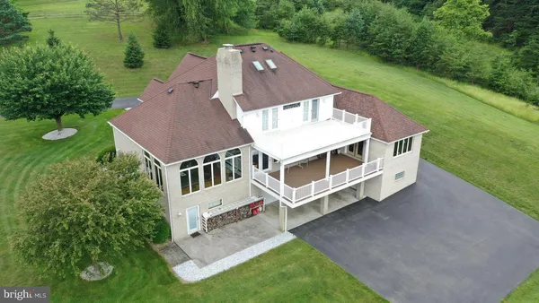a backyard of a house with a yard and outdoor seating