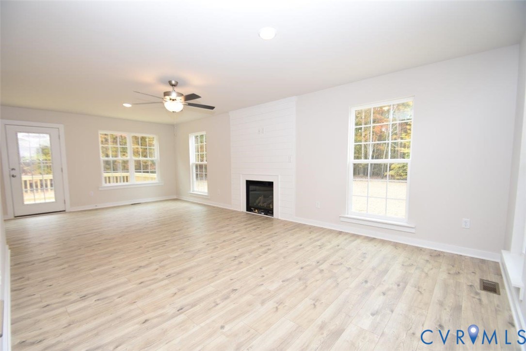 375 Amick Road Louisa, VA 23093 - Photo 8 of 25 wooden floor chandelier and windows in a room