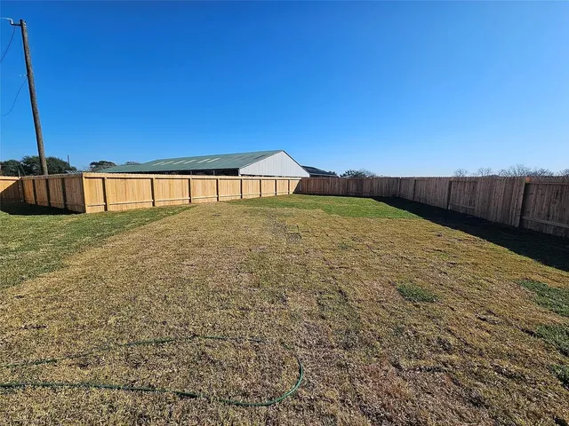 a living room with furniture a large window and a table
