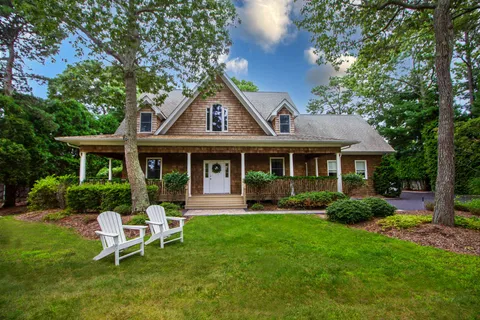 a view of a house with a yard porch and sitting area