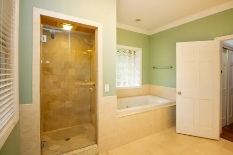 a bathroom with a tub a sink and a shower