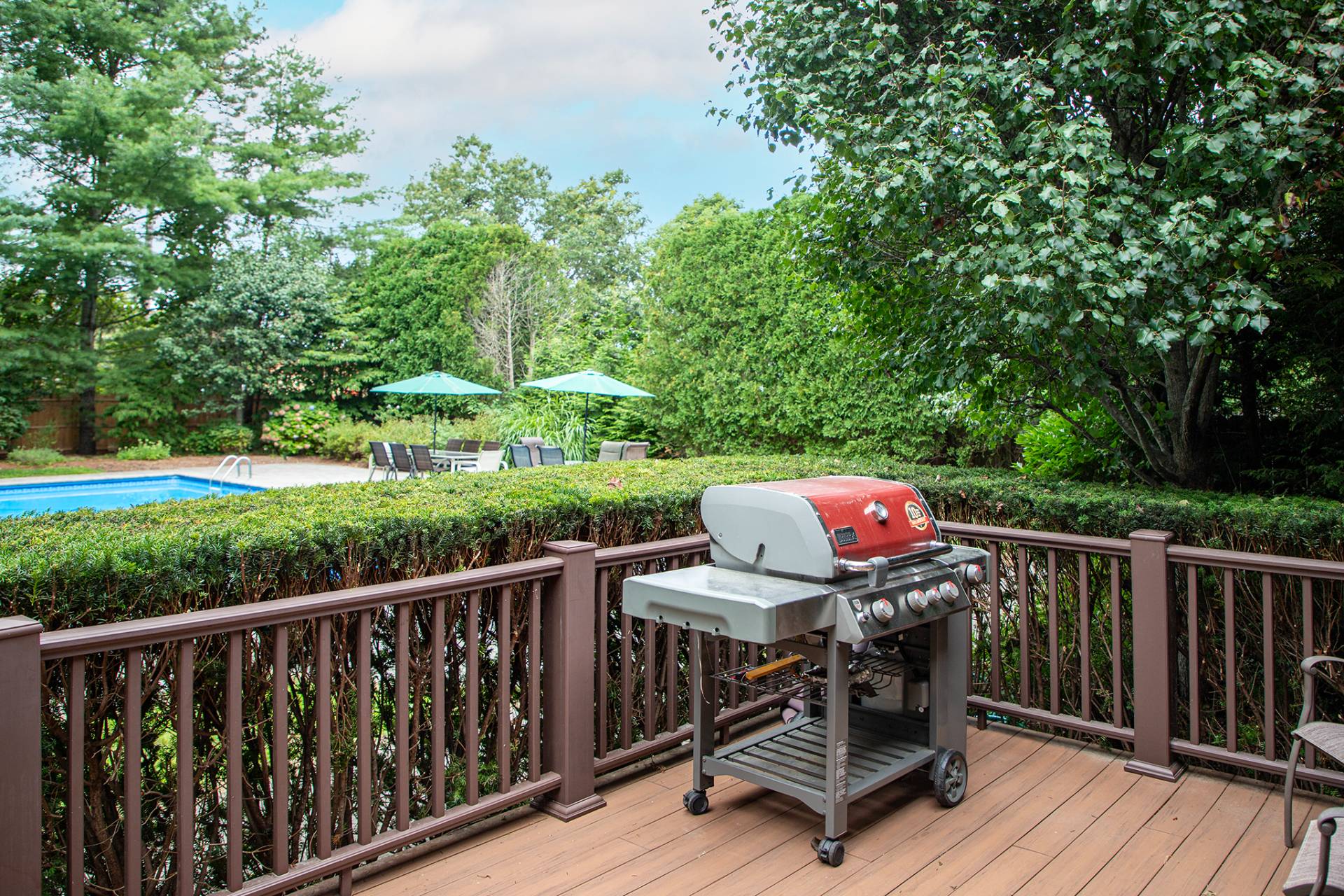 49 Bridle Path Westhampton Beach, NY 11978 - Photo 25 of 29 a view of a deck with furniture and trees around