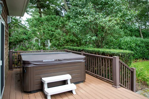 a view of a roof deck with wooden floor and fence