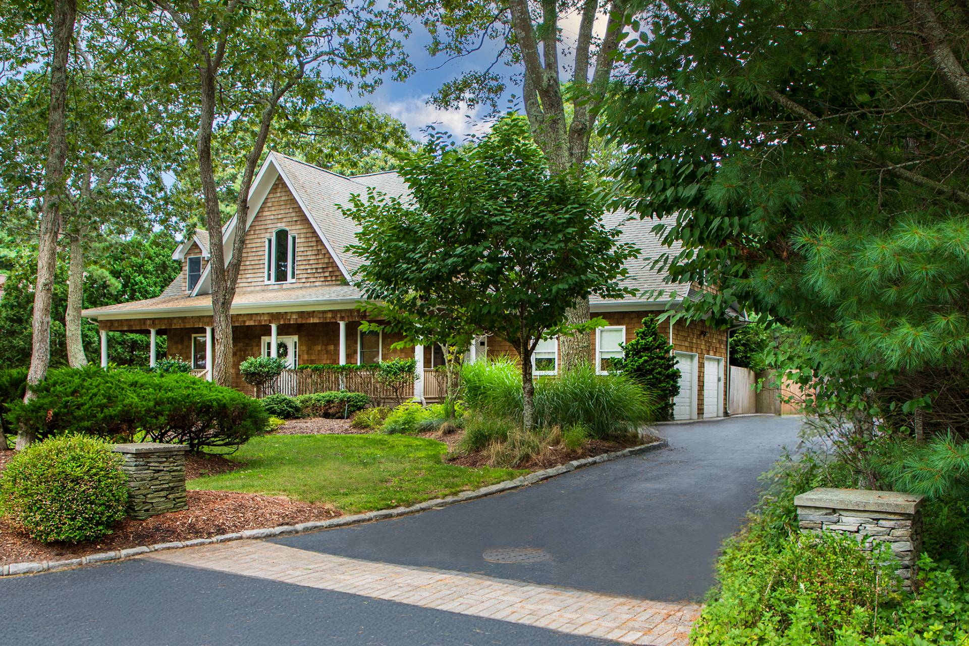 49 Bridle Path Westhampton Beach, NY 11978 - Photo 29 of 29 a front view of a house with a yard and potted plants