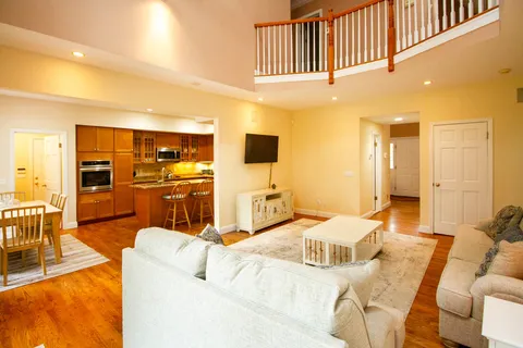 a bedroom with a bed a couch and dresser